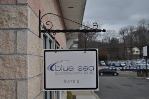 Sobieski Wayfinding Signs outdoor hanging blade sign blue sea building business wayfinding address sign 300x199